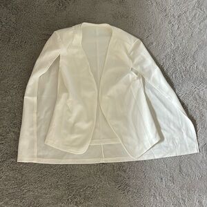 White blazer with cape back and shoulder pads inside; worn once for fashion show